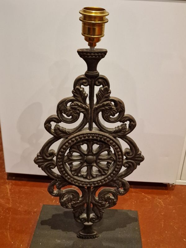Ornate cast-iron lamp base with a brass lampholder
