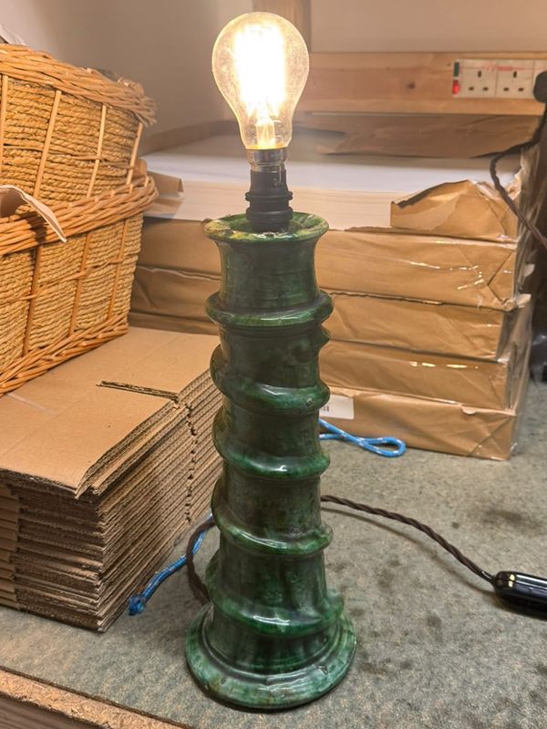 Green glazed pottery lamp, switched on